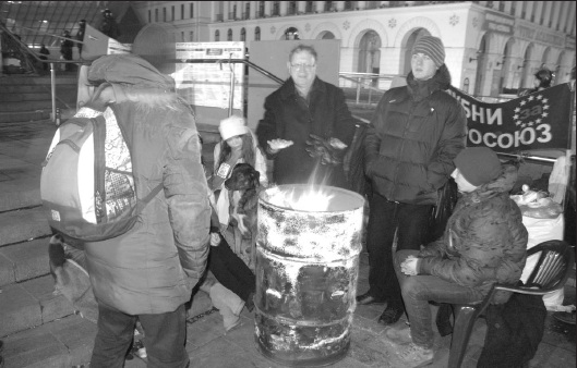 2 - Maidan eye witness Wolodymyr Derzko warms up on EuroMaidan just before Berkut riot police storm the students