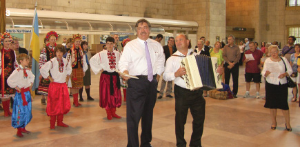 3 – Serenaded in song from London, Ont.; words and sung by Steve Andrusiak, music and accordion accompaniment by Ihor Zhylyak. Standing far right, Daria Hryckiw, President, UCC London Branch