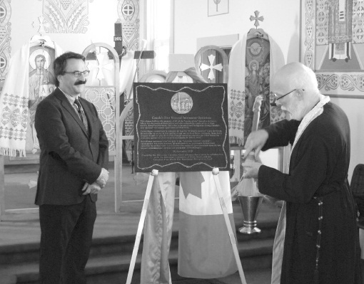 Father Roman Dusanowskyj symbolically blessing Dr. Lubomyr Luciuk and all of UCCLA’s volunteers